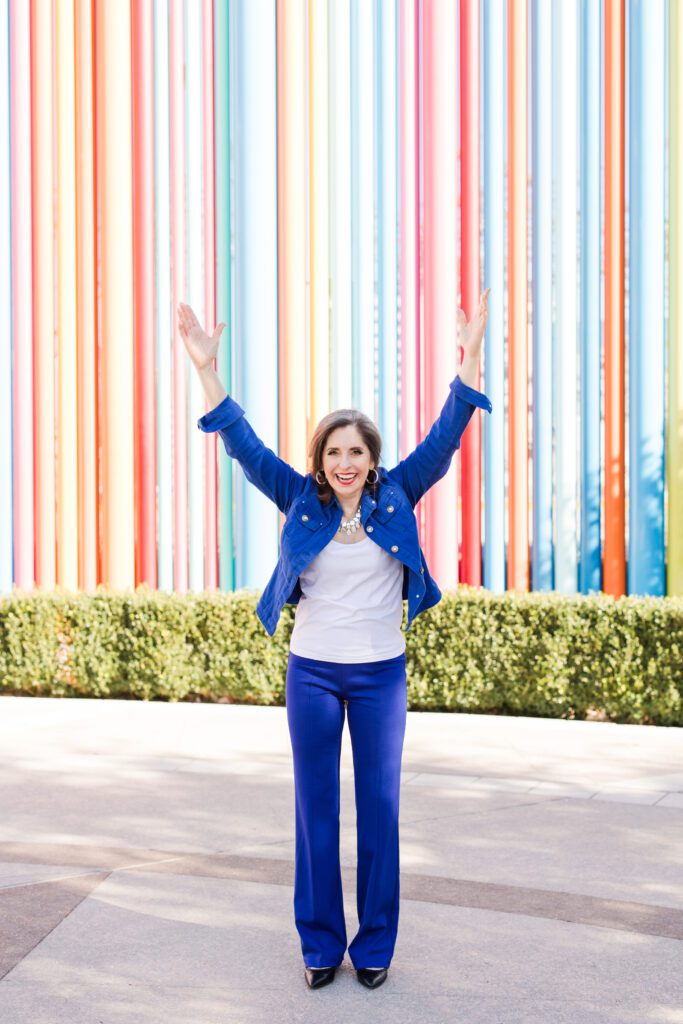 Maureen posing outside in a vibrant blue suit