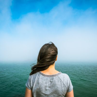 women looking into large body of water